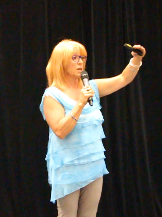 Yvonne Thompson giving a talk on a stage